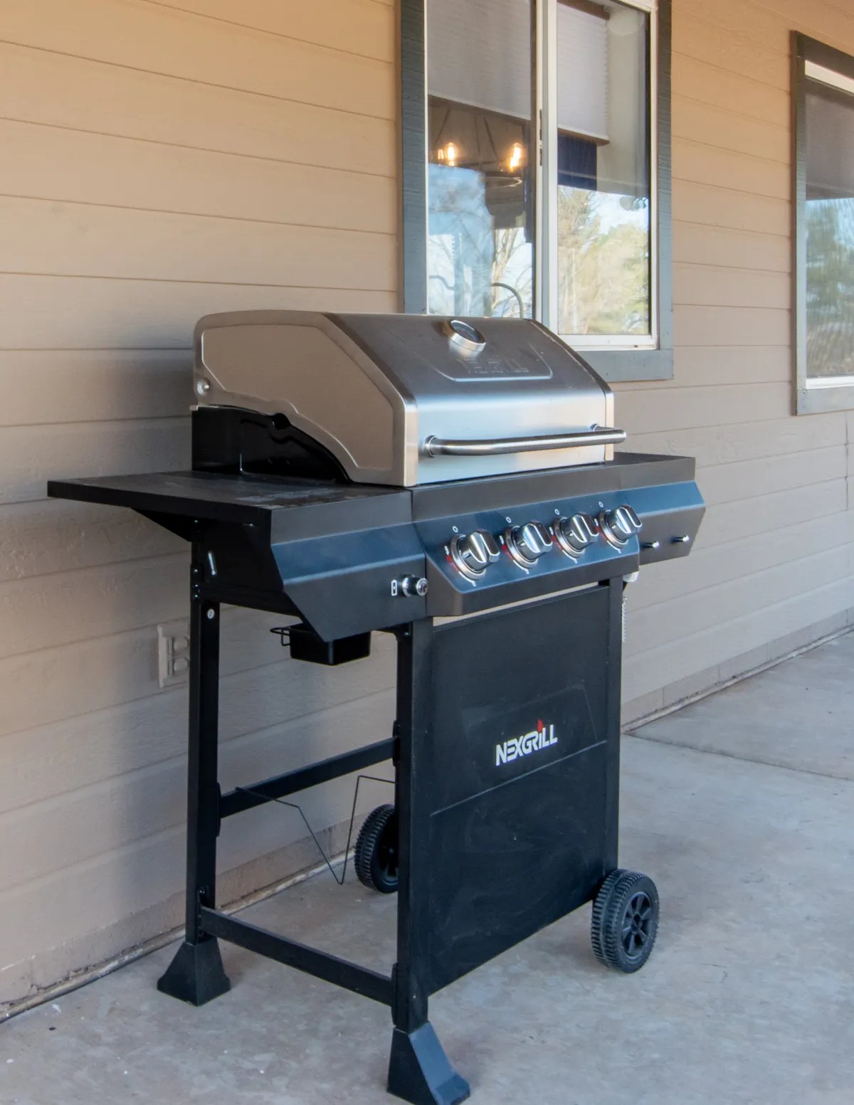 An exterior shot featuring a grill, windows, and an outdoor seating area. The scene suggests the transition from indoor dining to outdoor experiences, perfect for barbecues, entertaining, and sunset toasts.